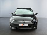 the front view of a black volkswagen vw golf parked in a showroom