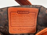 the inside of a coach handbag with a brown leather handle
