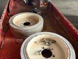 two tires sitting in the back of a red truck