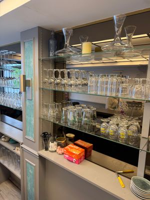 many glasses on the shelves in the kitchen