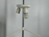 a white object on a stand with a metal pole