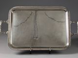 an antique silver tray with handles and handles on a stand