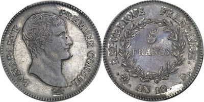a close up of a coin with a man ' s head on it