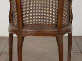 an old wooden chair with a cane back and a cane seat
