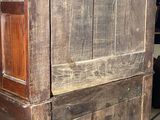 an old wooden cabinet with a door on top of it