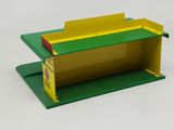 a green and yellow shelf with a yellow box on it