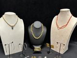 several different types of jewelry displayed on display on a black background