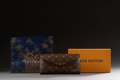 two louis vuitton wallets and a box on a table