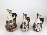 three vases sitting next to each other on a table