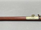 an old wooden pipe with brass fittings sitting on a table