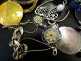 a lot of necklaces that are laying on a table