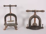 two old fashioned ironing tools sitting side by side