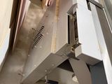 a machine that is working on a piece of wood