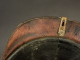 a close up of a leather hat with a metal buckle