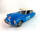 a blue toy car with a yellow top on a white surface