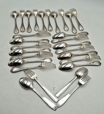 a lot of spoons and forks arranged in a heart shape