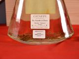 a glass flask with a label on it sitting on a table
