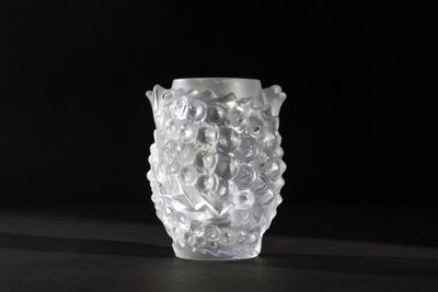 a close up of a glass vase on a table