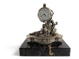 a clock that is sitting on top of a marble block