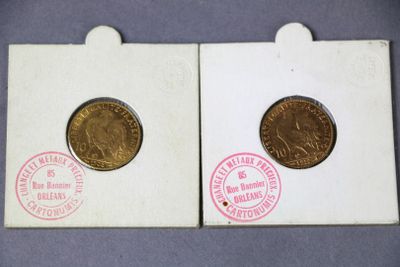 two coins are sitting on top of each other on a table