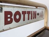 a sign that says bottin on the side of a bench
