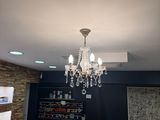 a chandelier hanging from the ceiling in a bathroom