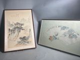 two framed asian paintings of mountains and trees on a blue background
