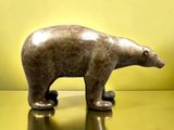 a statue of a polar bear on a shiny surface