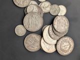 a pile of silver coins sitting on a table