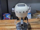 a coffee maker sitting on top of a wooden table