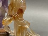two figurines that are sitting next to each other