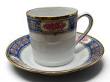 a cup and saucer on a saucer on a white surface