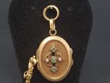 a close up of a gold locke with a key on a black stand