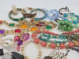 a pile of assorted jewelry sitting on a table