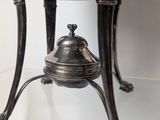a silver bowl on a stand with a lid