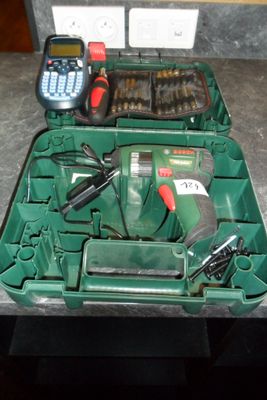 a green case with tools in it sitting on a counter