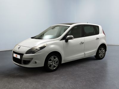 a picture of a small white car parked in a room