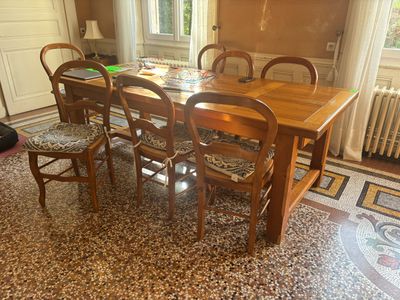 a table and chairs in a room with a tile floor