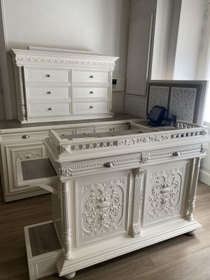a large white bed sitting in the middle of a room