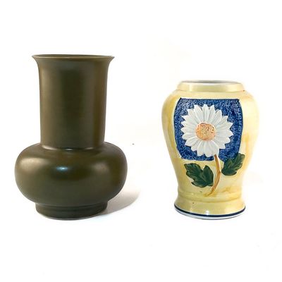 deux vases posés l'un à côté de l'autre sur une surface blanche
