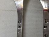 two spoons and a fork sitting on a table