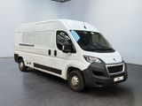 the white van is parked in the large room of the building