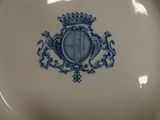 a blue and white plate with a crown on it