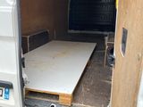 a bed in the back of a van with the door open