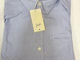 a close up of a blue and white striped shirt with a tag on it