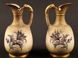 two vases with blue and white designs on them sitting on a table