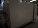 an image of a white refrigerator in a warehouse