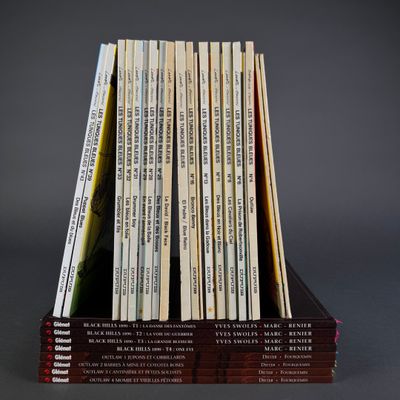 books stacked on top of each other in a wooden holder