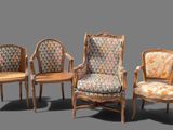 three chairs and a chair with a cushion on a gray background