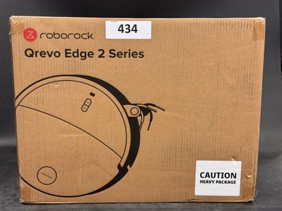a close up of a cardboard box with a clock on it